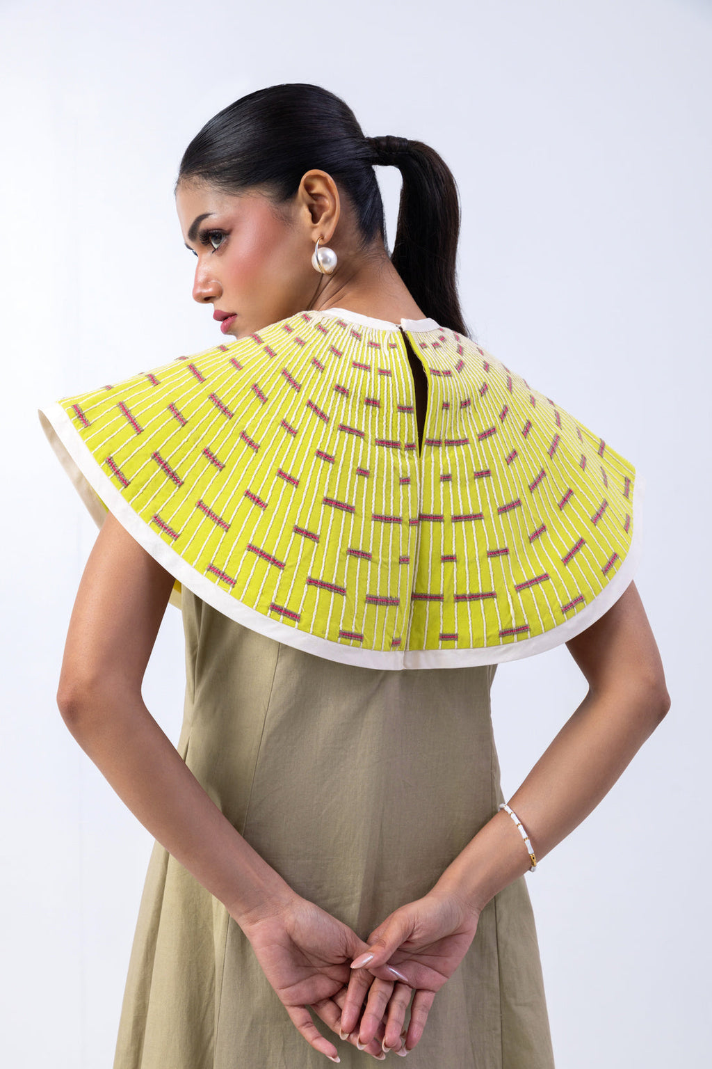 Aureate Arc dress in Sand Stone with Luster Lime hand-embroidered cape — front view
